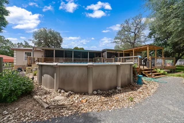 a view of a blue swimming pool with a patio