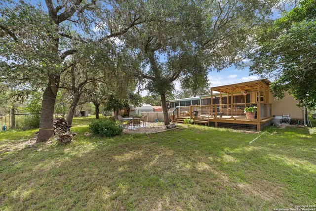 a view of a house with backyard and sitting area