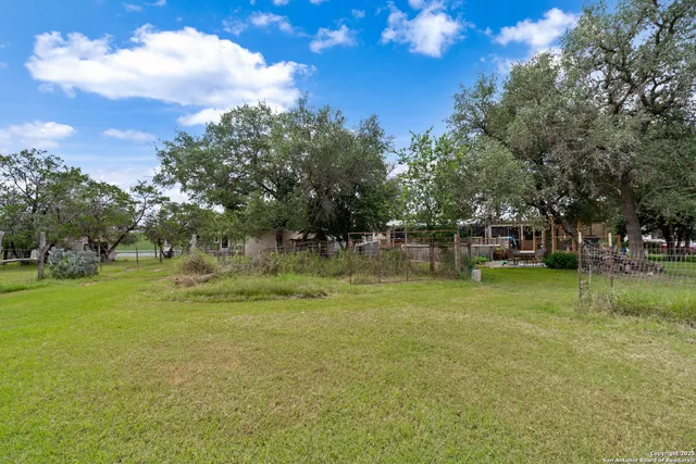 a view of outdoor space with garden and trees