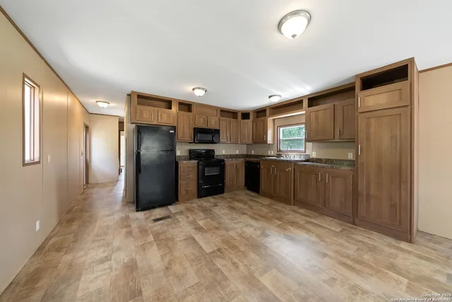 a kitchen with stainless steel appliances granite countertop a refrigerator and a sink