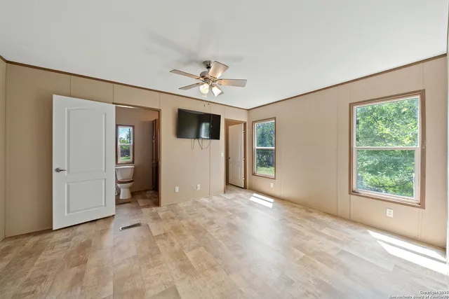an empty room with windows and closet