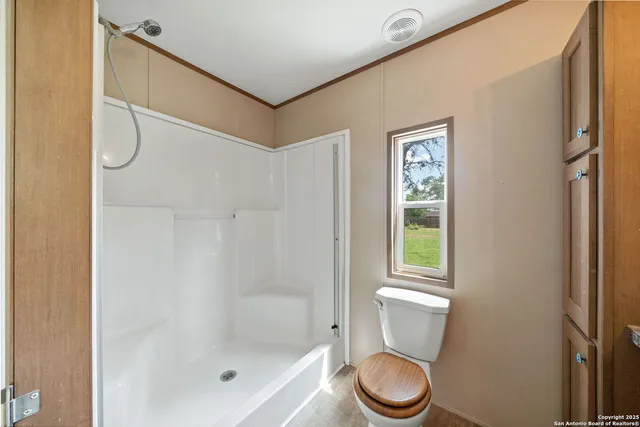 a bathroom with a toilet a sink and a shower