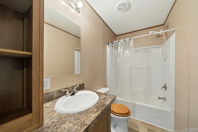 a bathroom with a sink a toilet and a mirror