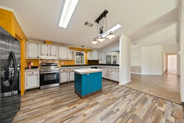 a large kitchen with cabinets and stainless steel appliances