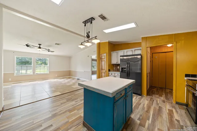 a spacious bathroom with a sink a large mirror and a shower