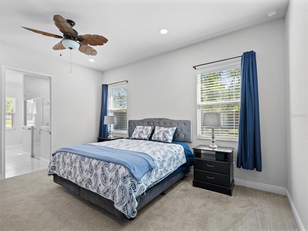 11981 Robina Road Weeki Wachee, FL 34614 - Photo 21 of 93 a bedroom with a bed and a large window