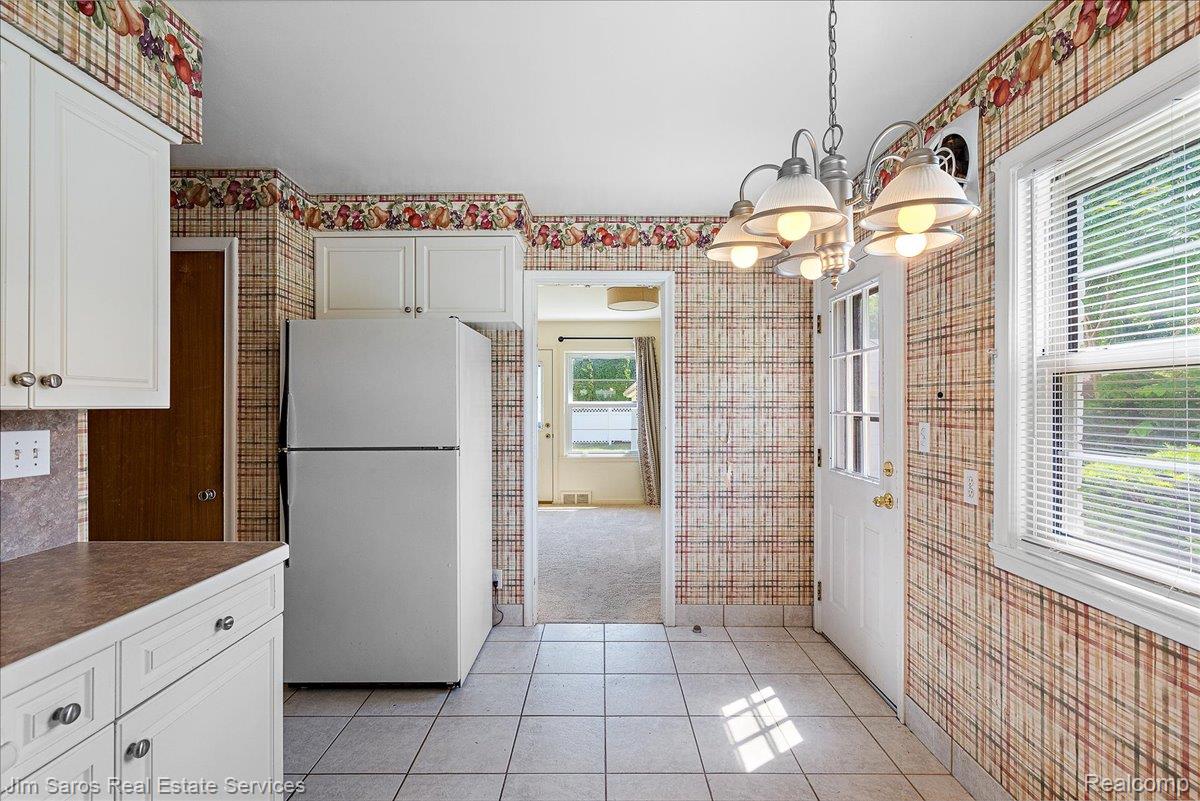 1010 Nottingham Road Grosse Pointe, MI 48230 - Photo 10 of 30 Kitchen featuring white cabinetry, tile flooring, and a white paneled door with window inserts