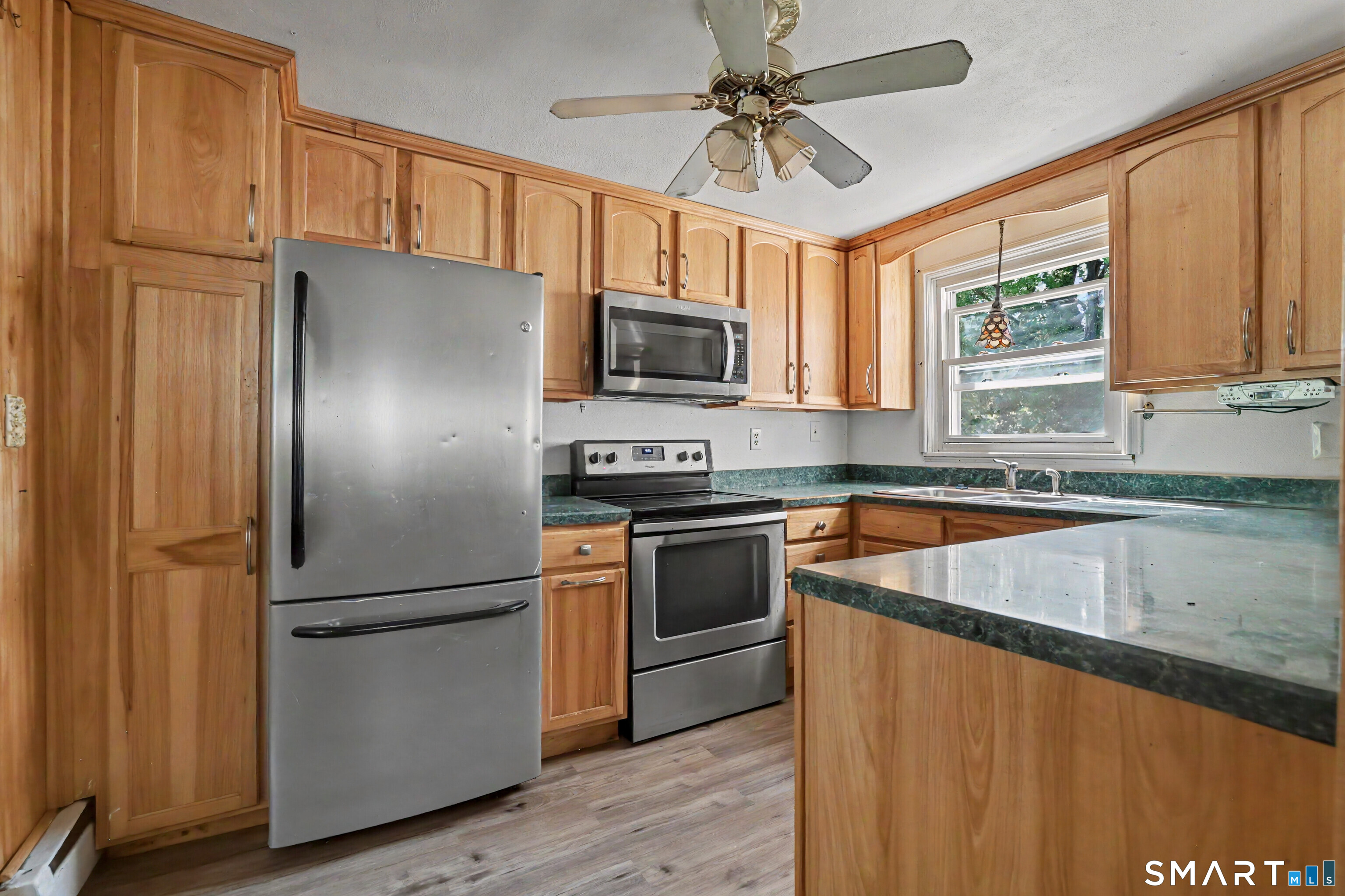 97 Boothbay Street Bloomfield, CT 06002 - Photo 9 of 33 a kitchen with granite countertop stainless steel appliances a refrigerator cabinets and a sink