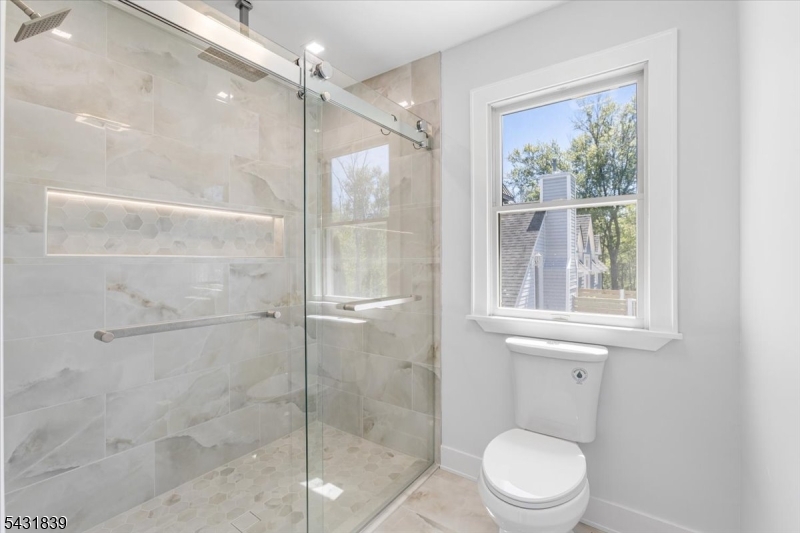 15 Spring Hunter Court Andover, NJ 07821 - Photo 31 of 49 a bathroom with a shower a toilet and a window