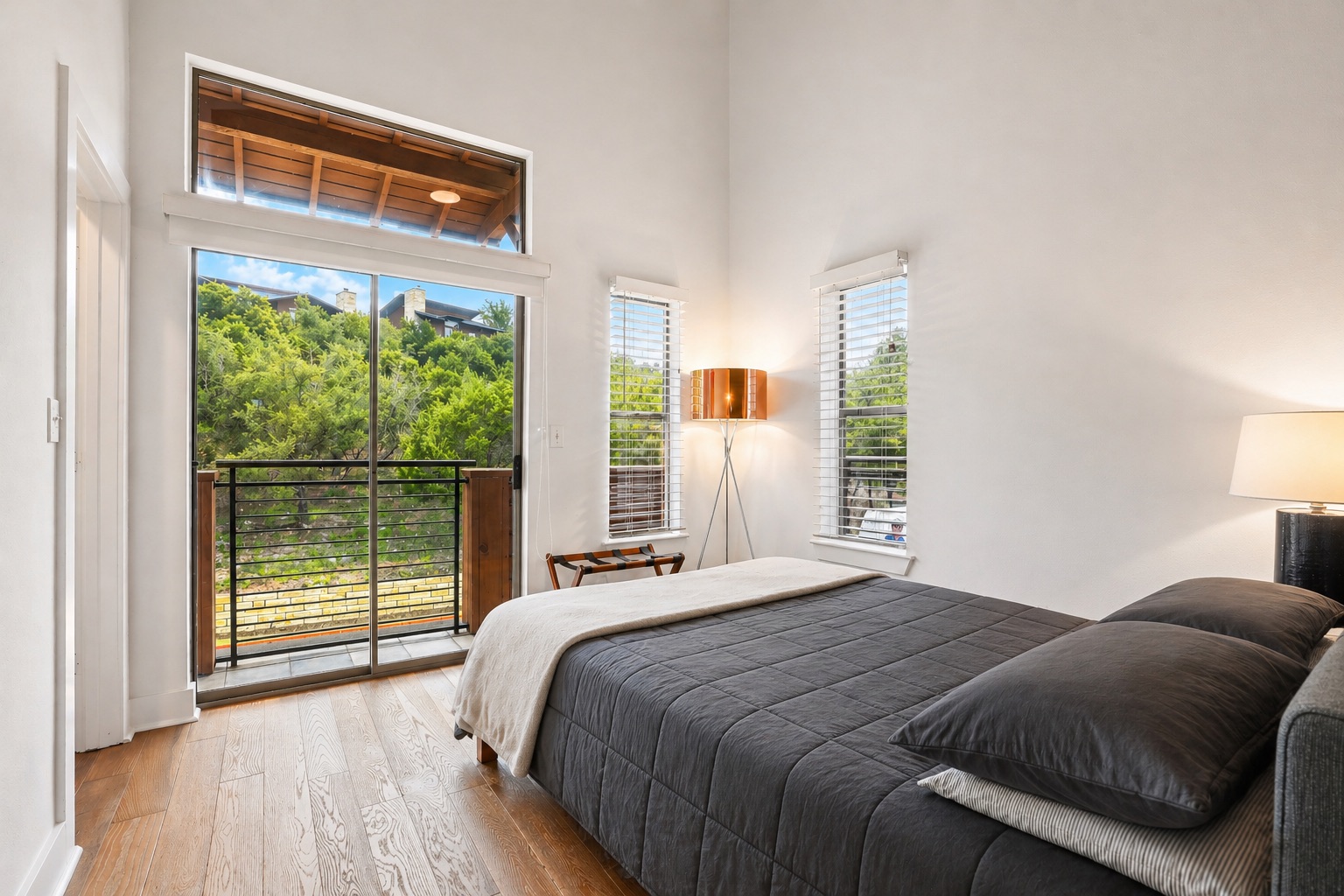 8110 Ranch Road 2222, Unit 10 Austin, TX 78730 - Photo 14 of 23 a bedroom with a bed and a large window