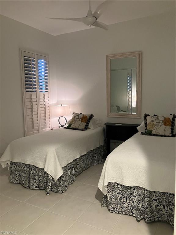 4080 Trinidad Way Naples, FL 34119 - Photo 13 of 15 a bedroom with bed and window