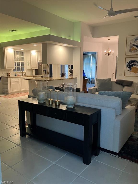 4080 Trinidad Way Naples, FL 34119 - Photo 2 of 15 a view of living room with granite countertop furniture and fireplace