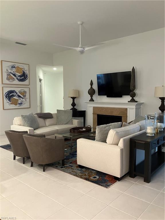 4080 Trinidad Way Naples, FL 34119 - Photo 6 of 15 a living room with furniture and a flat screen tv