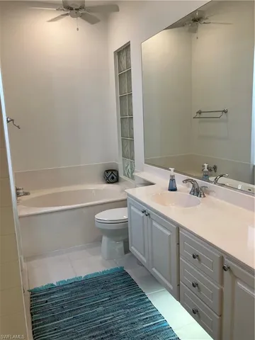 a bathroom with a double vanity sink toilet and shower