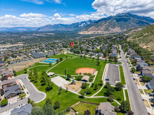 14883 Tooele Lane Draper, UT 84020 - Photo 10 of 49 Expansive community green space featuring a tennis court, baseball field, and playground equipment