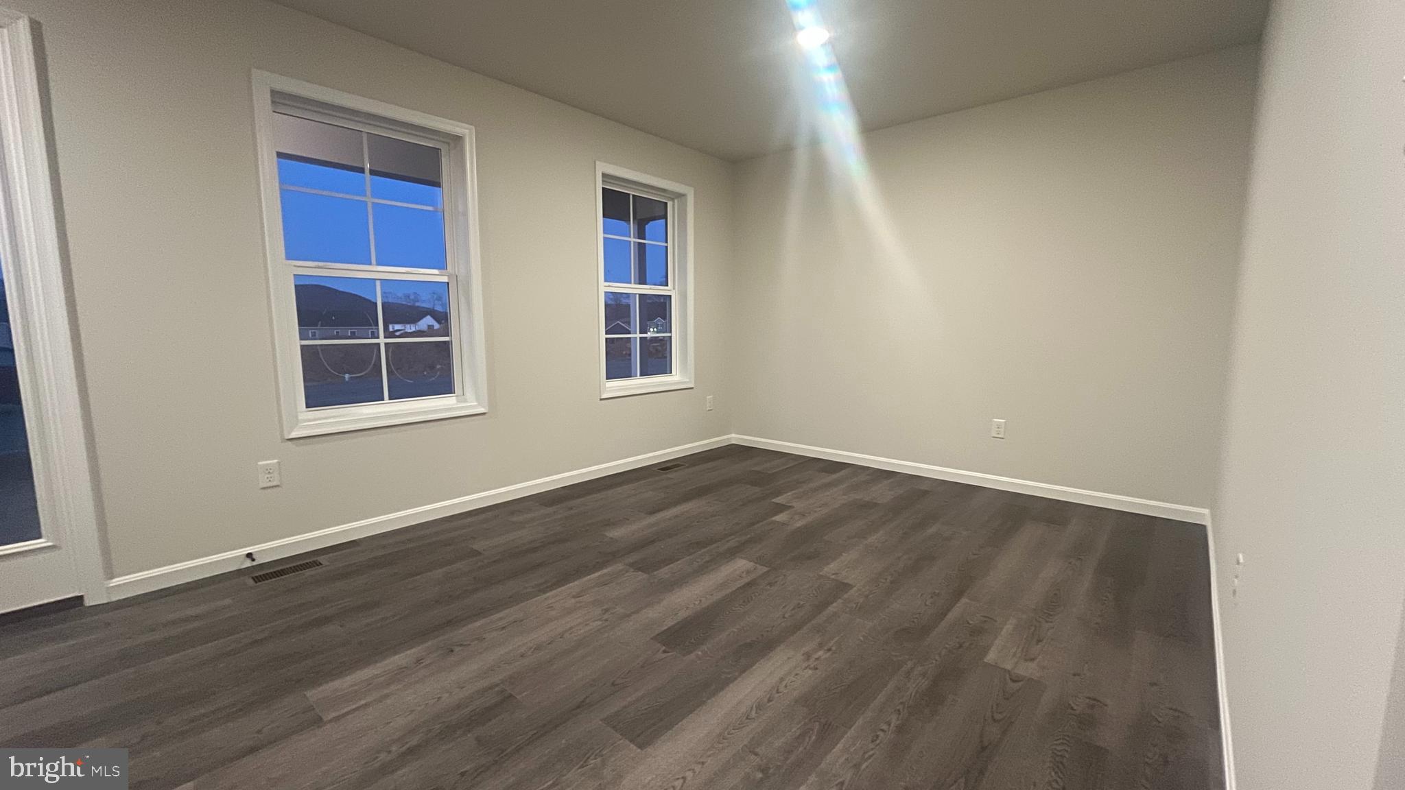 10030 Pendleton Avenue Waynesboro, PA 17268 - Photo 14 of 36 an empty room with wooden floor and windows
