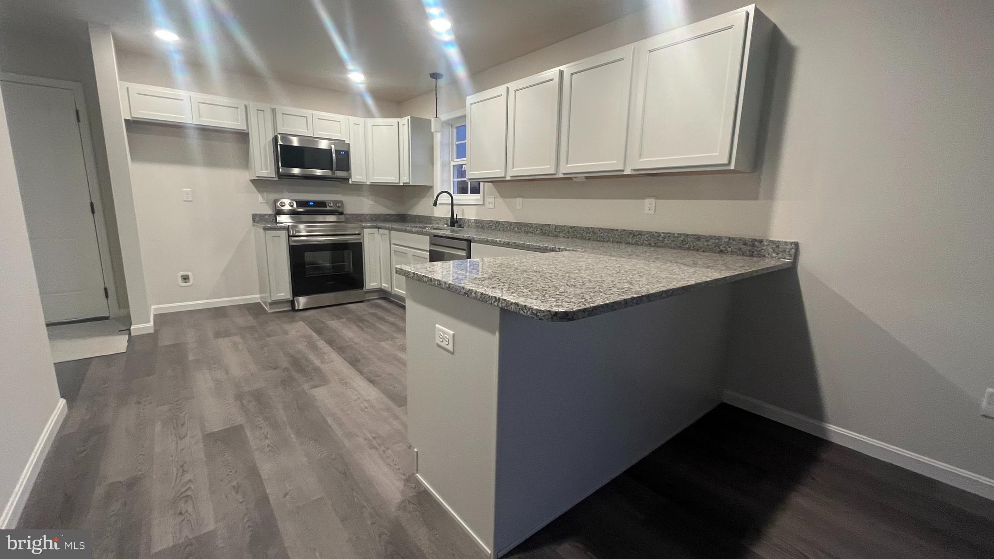 10030 Pendleton Avenue Waynesboro, PA 17268 - Photo 6 of 36 a kitchen with kitchen island white cabinets appliances and a counter top