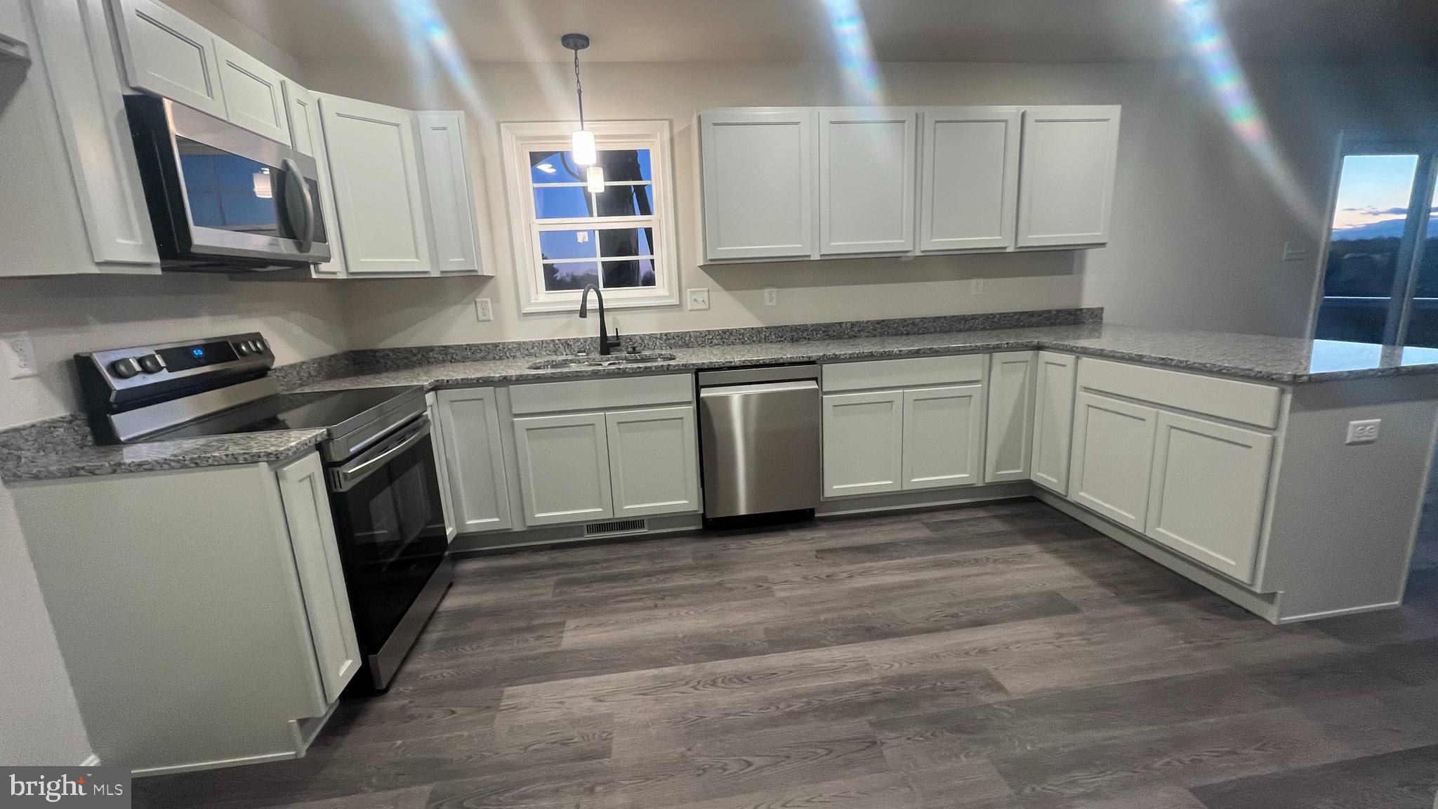 10030 Pendleton Avenue Waynesboro, PA 17268 - Photo 8 of 36 a kitchen with stainless steel appliances granite countertop a stove a sink and a microwave