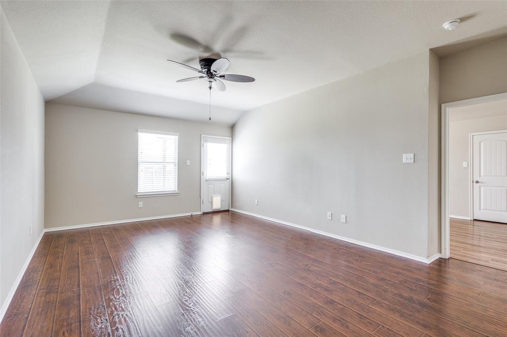 1101 Rainer Drive Princeton, TX 75407 - Photo 11 of 25 a view of an empty room with wooden floor and a window