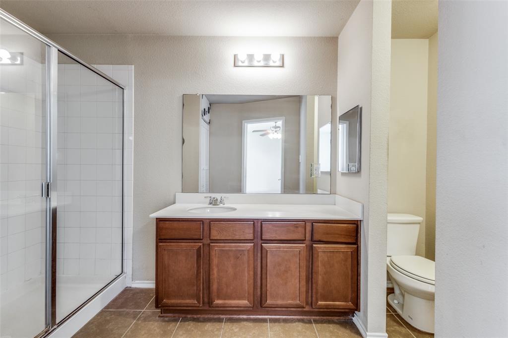 1101 Rainer Drive Princeton, TX 75407 - Photo 17 of 25 a bathroom with a sink a toilet and a mirror