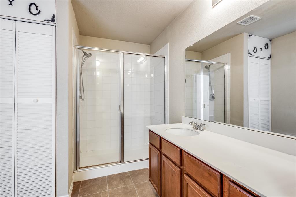 1101 Rainer Drive Princeton, TX 75407 - Photo 18 of 25 a bathroom with a double vanity sink and mirror