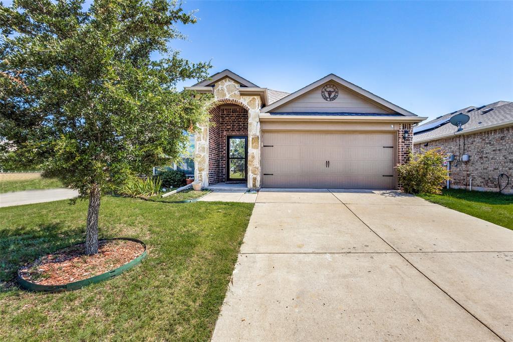 1101 Rainer Drive Princeton, TX 75407 - Photo 2 of 25 a front view of a house with a yard and garage