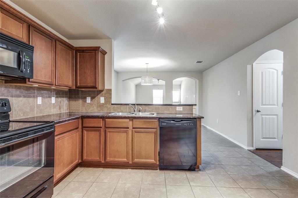1101 Rainer Drive Princeton, TX 75407 - Photo 5 of 25 a kitchen with a sink and a stove top oven