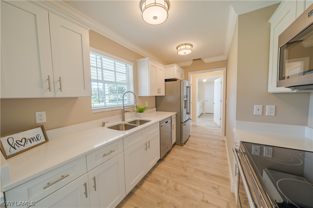 21510 North River Road Alva, FL 33920 - Photo 15 of 35 a large white kitchen with a sink and cabinets