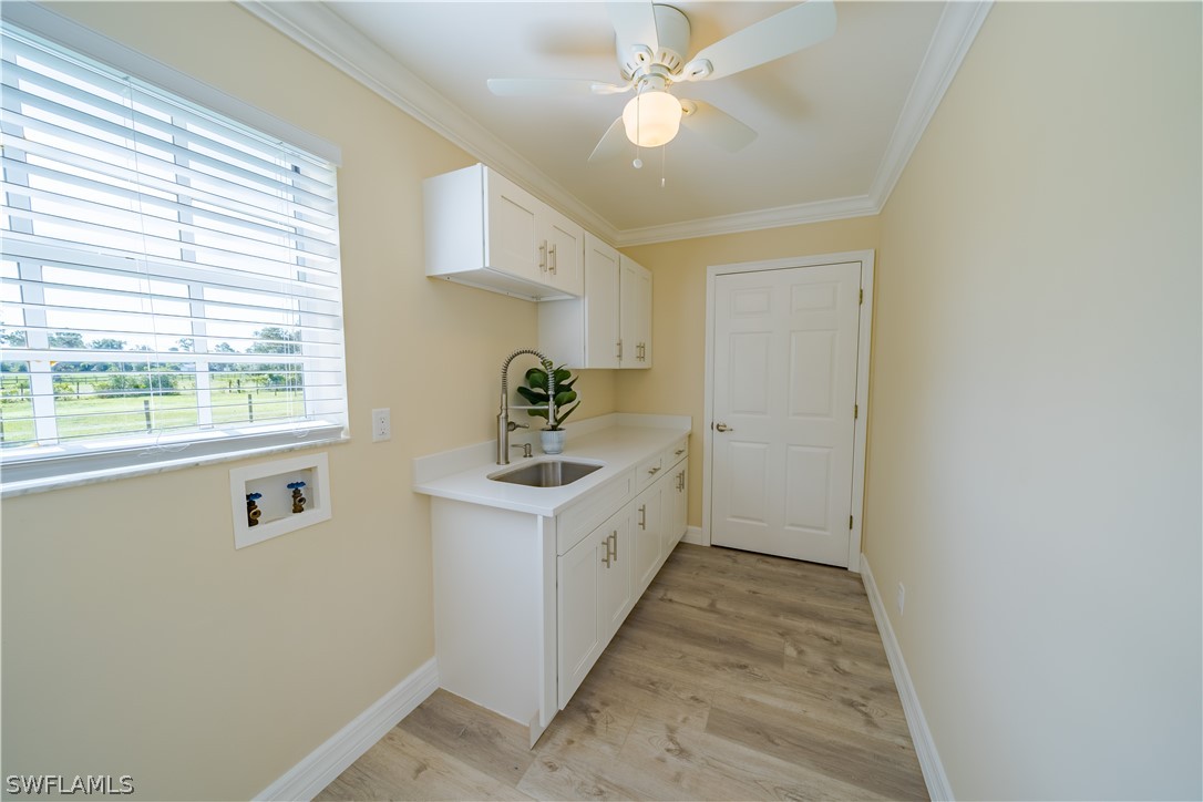 21510 North River Road Alva, FL 33920 - Photo 17 of 35 a view of a kitchen with a sink a window and cabinets