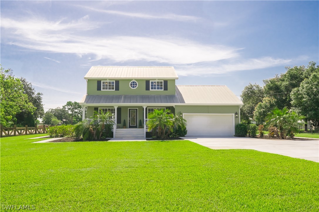 21510 North River Road Alva, FL 33920 - Photo 2 of 35 a front view of house with yard and green space