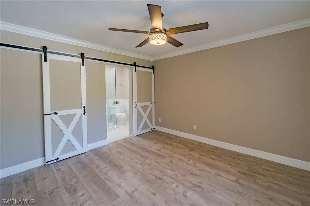 21510 North River Road Alva, FL 33920 - Photo 22 of 35 a view of an empty room with wooden floor and a ceiling fan