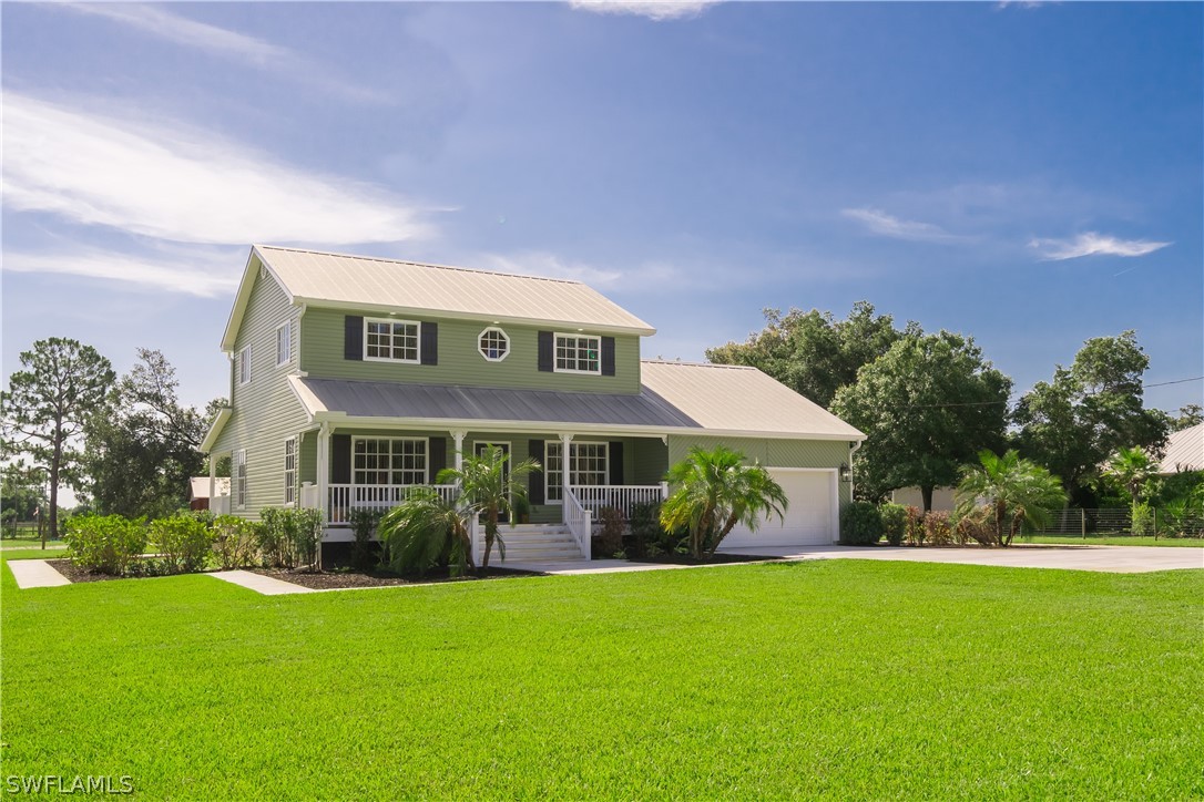21510 North River Road Alva, FL 33920 - Photo 3 of 35 a front view of a house with garden