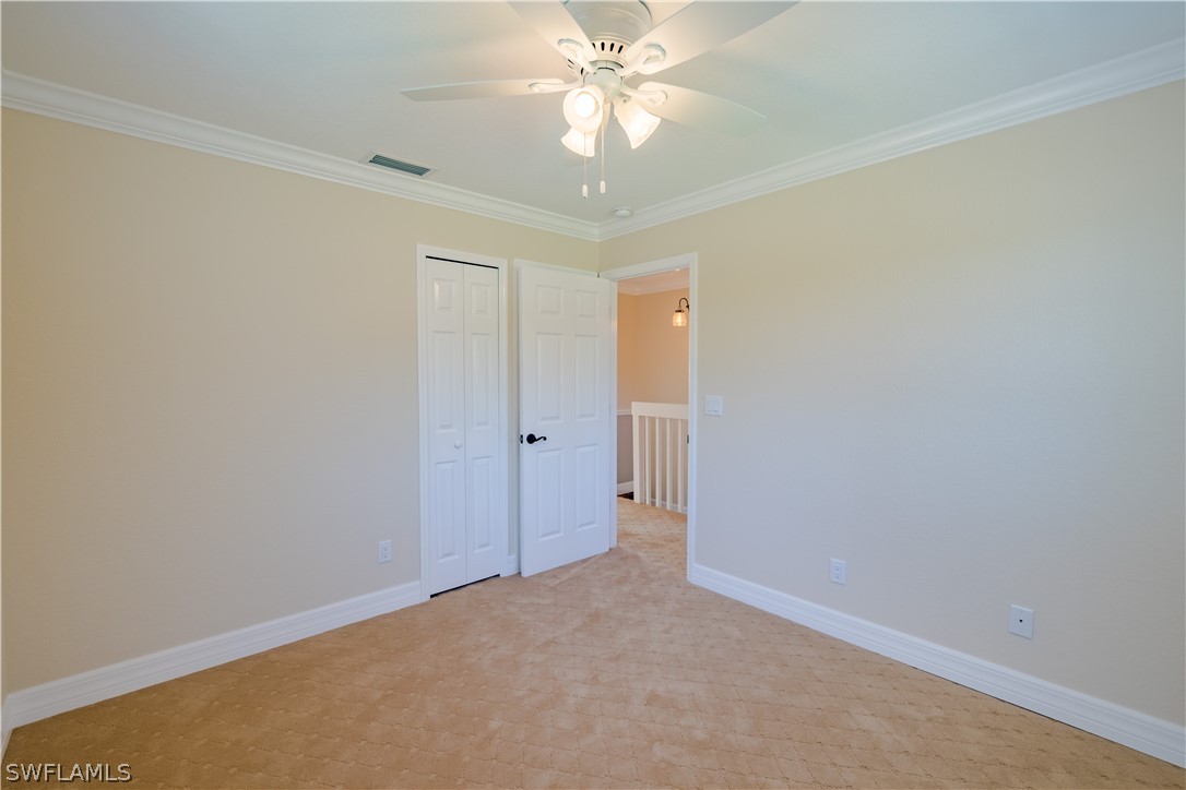 21510 North River Road Alva, FL 33920 - Photo 31 of 35 an empty room with a ceiling fan and a window