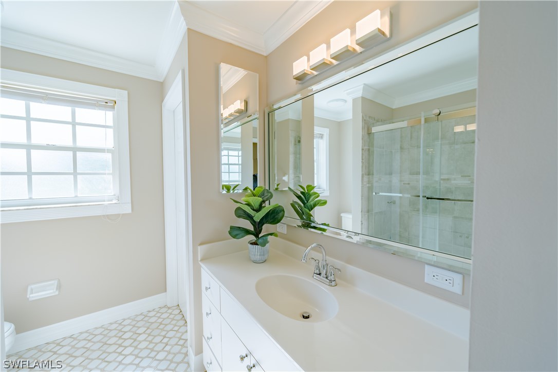 21510 North River Road Alva, FL 33920 - Photo 33 of 35 a bathroom with a sink a large mirror and a shower