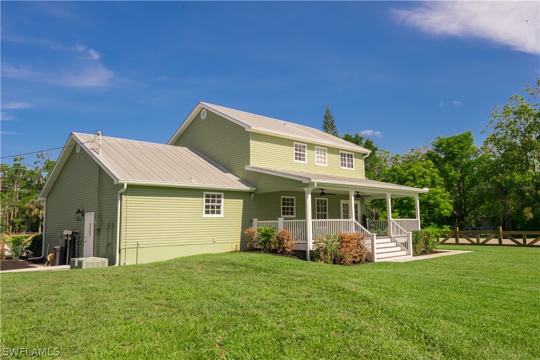 21510 North River Road Alva, FL 33920 - Photo 5 of 35 a view of a house with backyard sitting area and garden