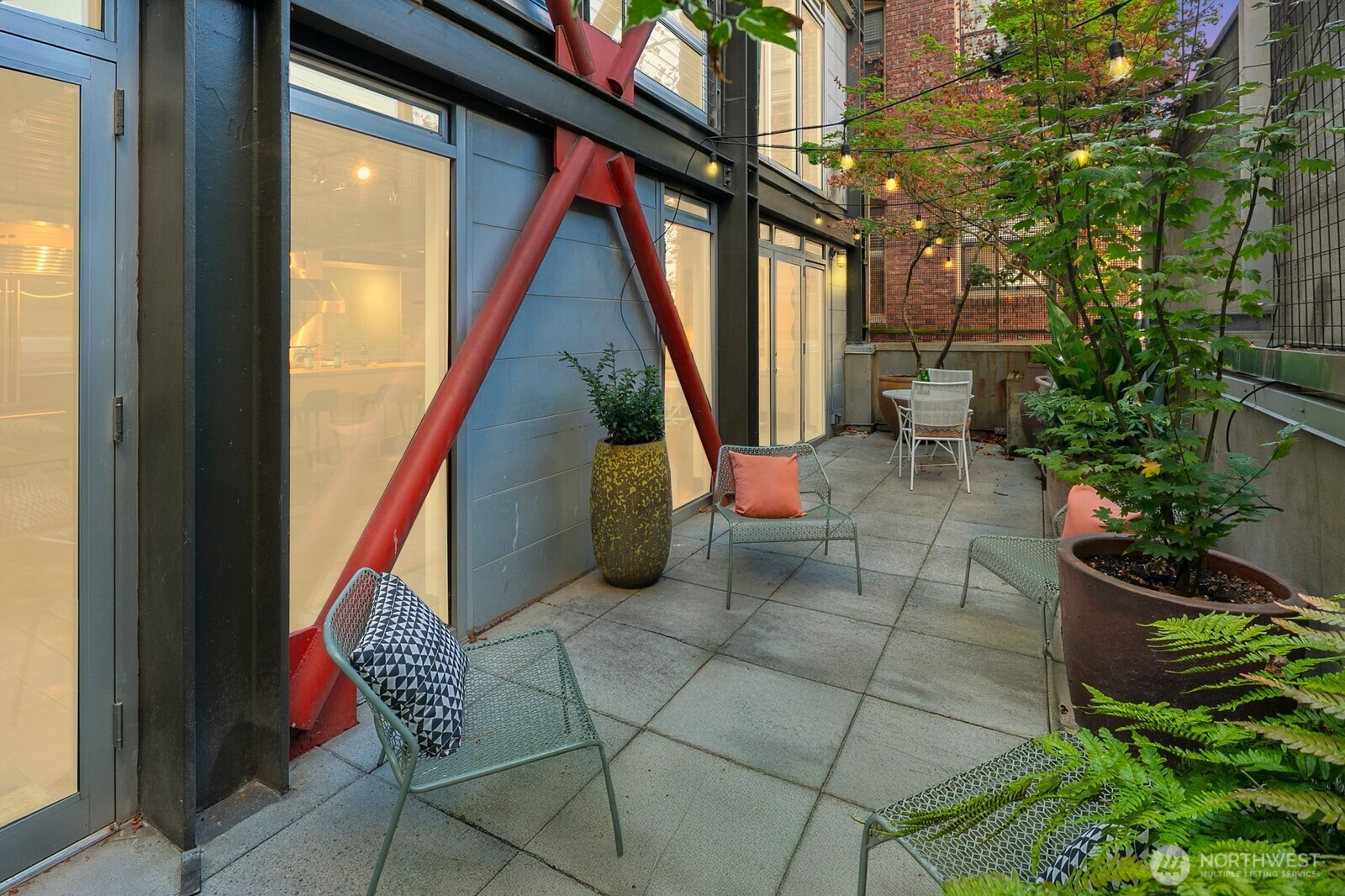 1310 East Union Street, Unit 202 Seattle, WA 98122 - Photo 1 of 31 a backyard of a house with outdoor seating