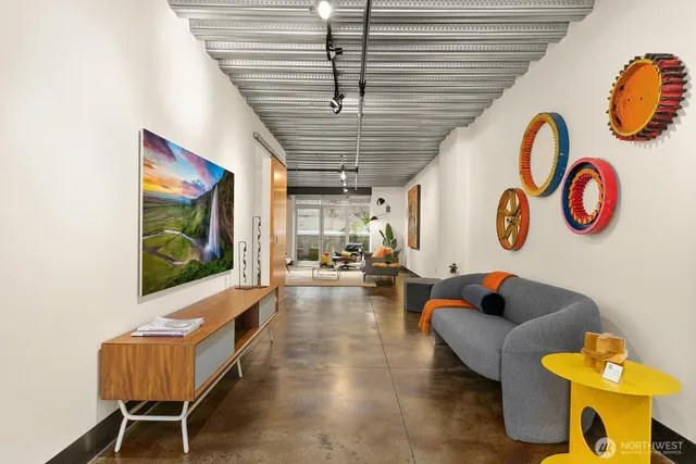 a living room with couch and a table with potted plants