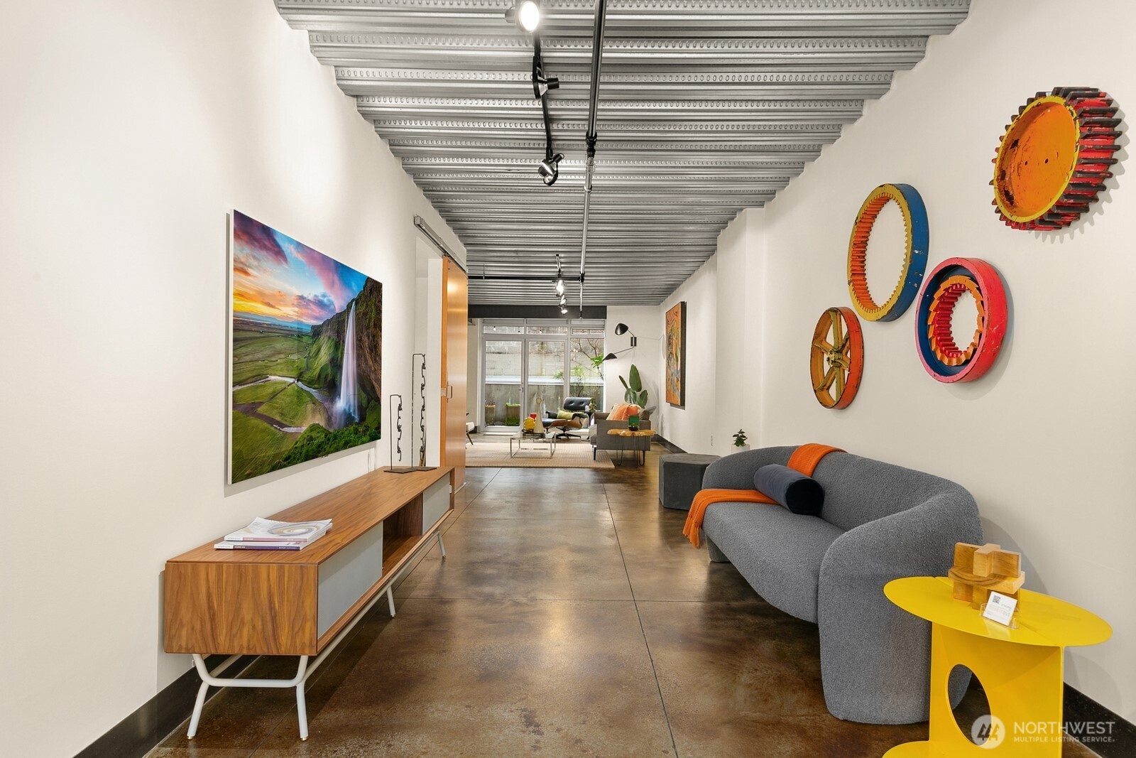1310 East Union Street, Unit 202 Seattle, WA 98122 - Photo 17 of 31 a living room with couch and a table with potted plants