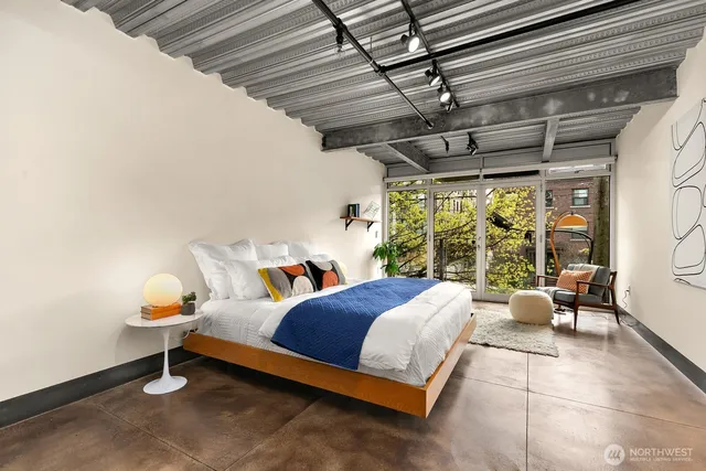 a bedroom with a bed and a window