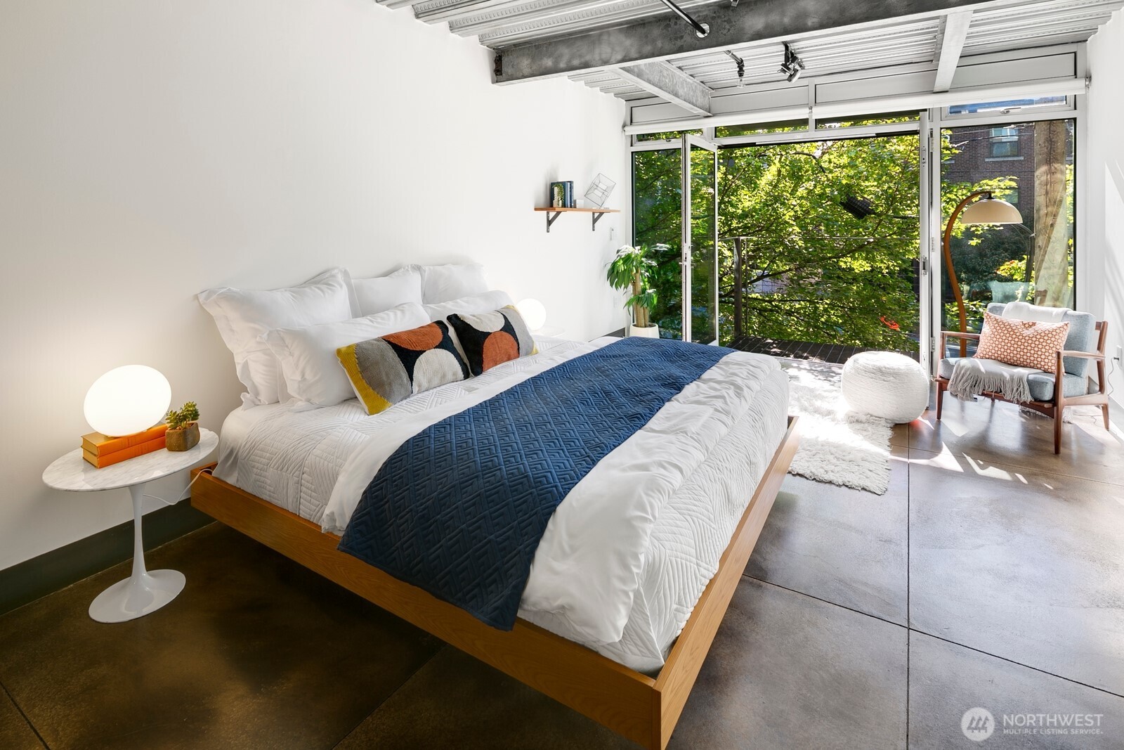 1310 East Union Street, Unit 202 Seattle, WA 98122 - Photo 22 of 31 a bed sitting in a bedroom next to a large window