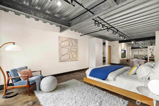 a bedroom with bed and a chandelier