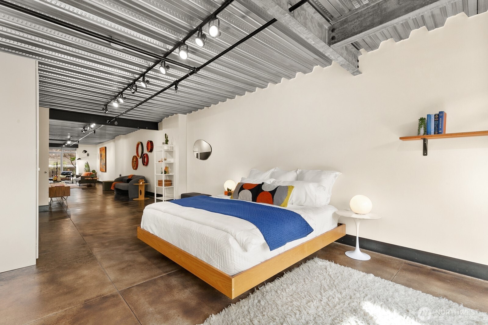 1310 East Union Street, Unit 202 Seattle, WA 98122 - Photo 25 of 31 a bed room with a bed and a walk in closet