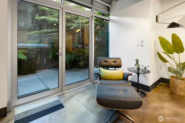 a living room with furniture and a floor to ceiling window
