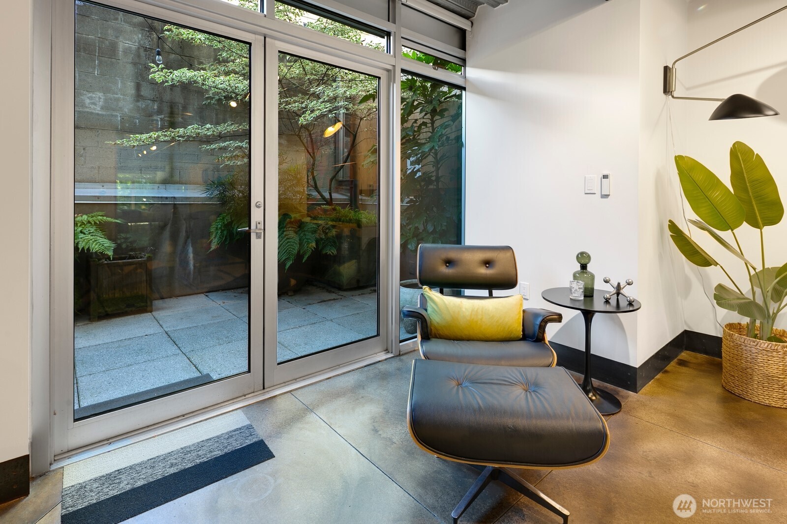 1310 East Union Street, Unit 202 Seattle, WA 98122 - Photo 6 of 31 a living room with furniture and a floor to ceiling window