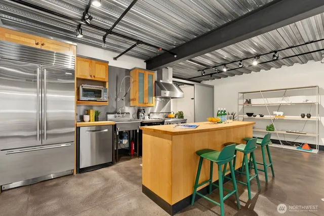 a kitchen with refrigerator and table