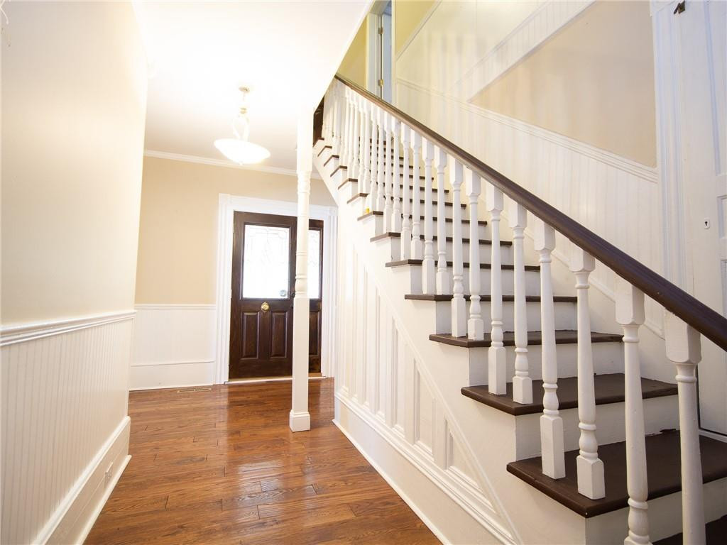 8076 Broad Street Rural Hall, NC 27045 - Photo 13 of 36 a view of staircase with wooden floor and white walls