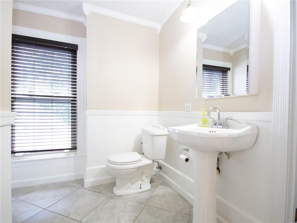8076 Broad Street Rural Hall, NC 27045 - Photo 25 of 36 a bathroom with a sink a toilet and a mirror