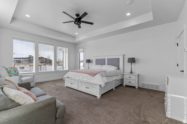 1426 South 1450th Street West Mapleton, UT 84664 - Photo 12 of 50 Spacious room featuring broad windows with blinds, recessed lighting, a modern ceiling fan, and tray ceilings