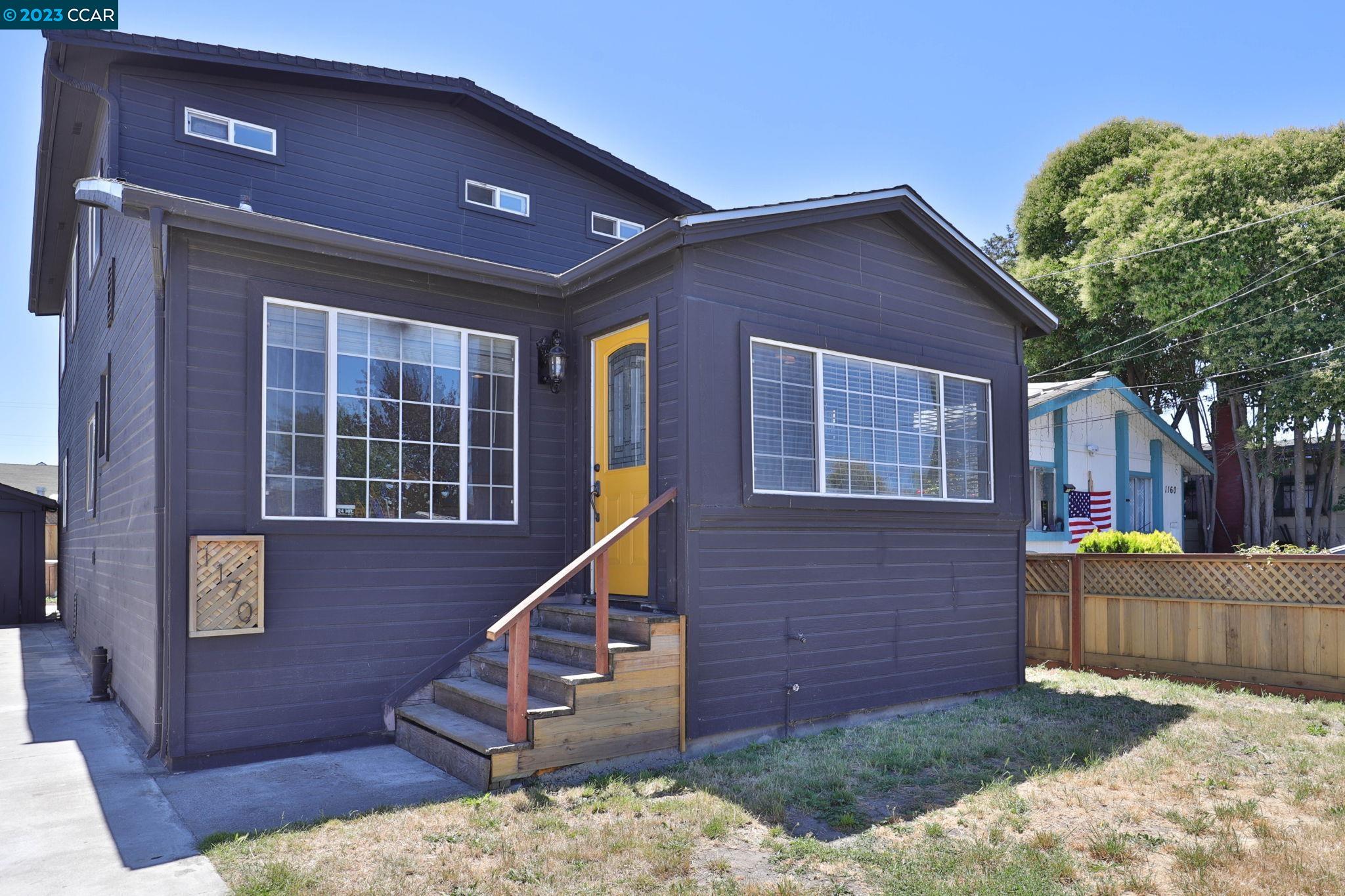 1170 61st Avenue Oakland, CA 94621 - Photo 1 of 26 a view of a house with a yard and stairs