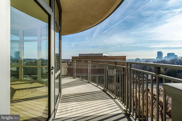 a bedroom with a bed a table and a large window